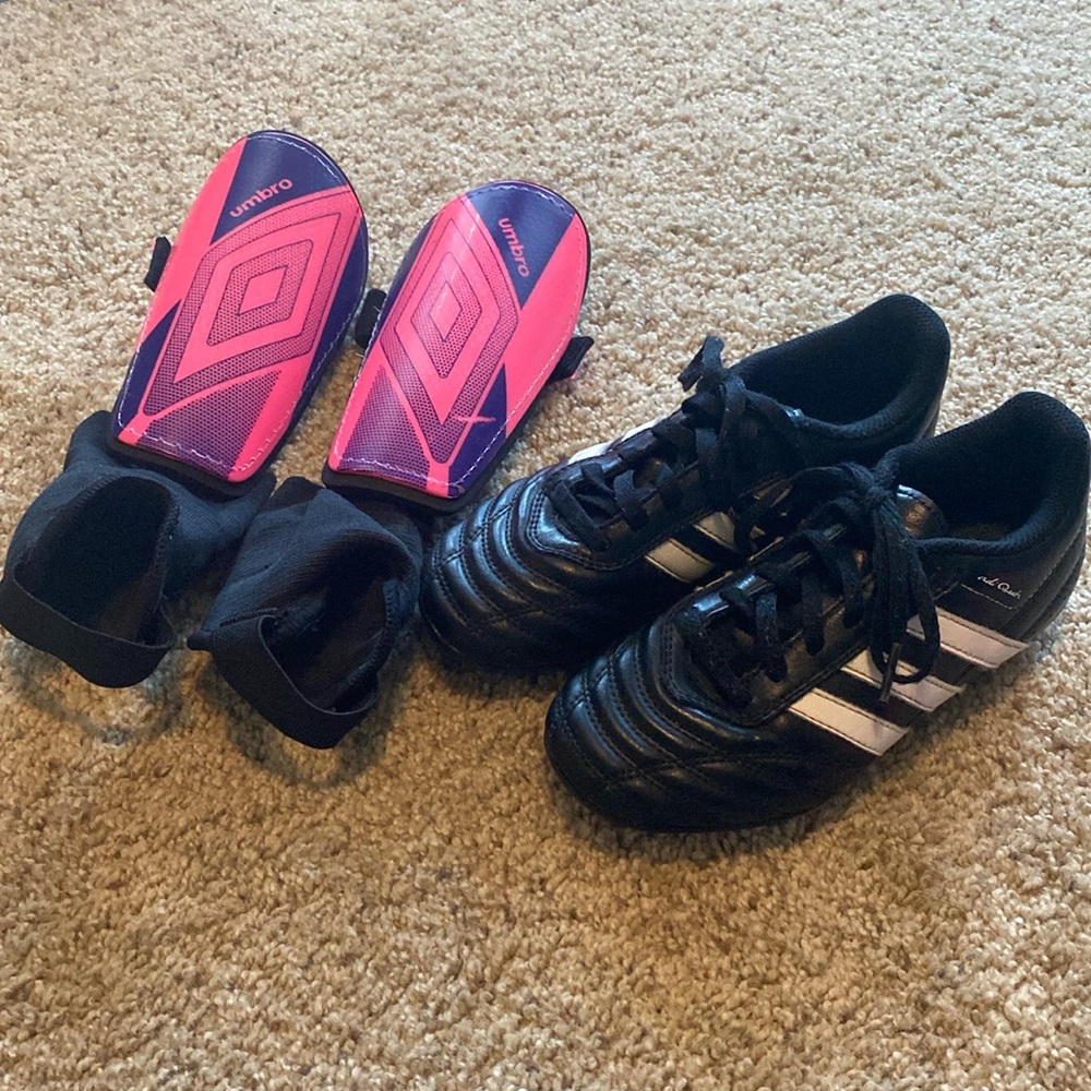 Youth Adidas soccer cleats size 1.5 and Umbro small shin guards.